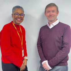 Photograph of Carmen Dillon (CEO of Welwyn Hatfield CVS) and Stephen Craker (Chief Executive of Communities 1st) standing together and smiling.