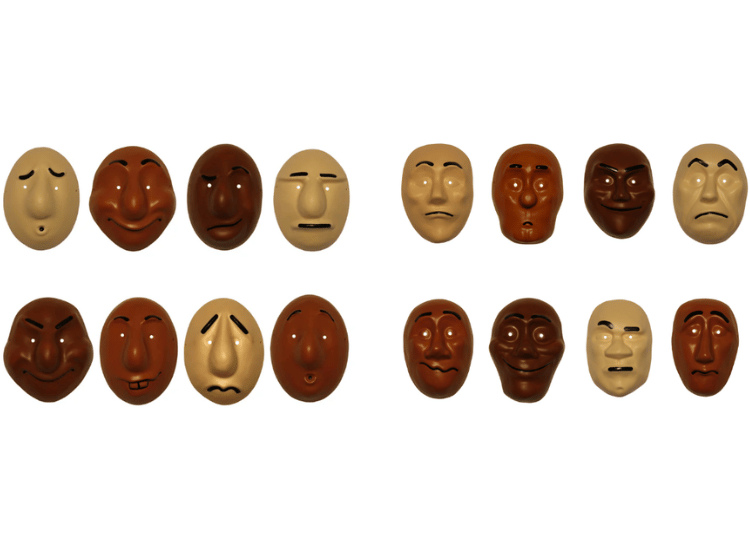 A collection of Trestles Theatre face masks with different expressions and skin tones, representing diversity, emotion, and inclusive community engagement. Trestle Theatre Co
