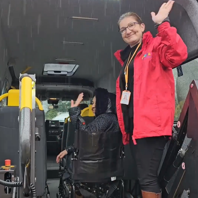 Waving driver operating wheelchair ramp