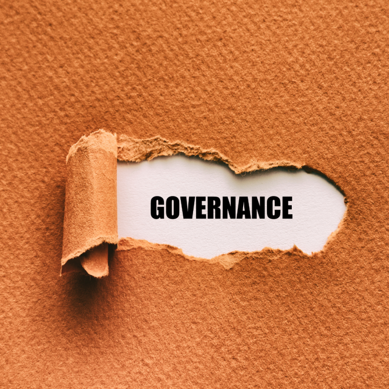 Torn sheet of paper with word 'GOVERNANCE' beneath