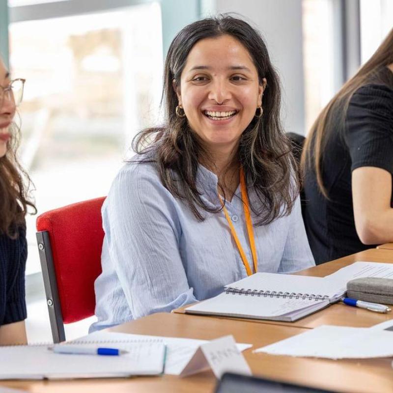 Smiling at a table in a professional setting.