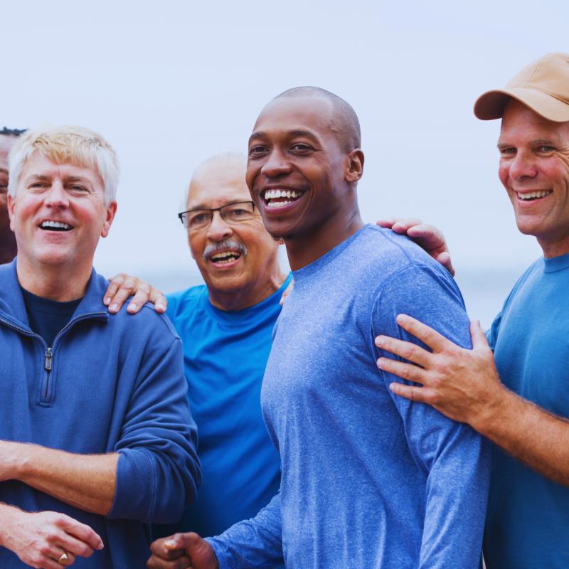 A group of five men, all wearing blue.
