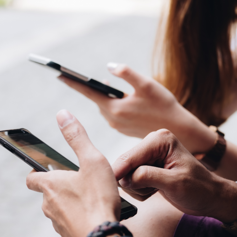 Two people holding their smartphones
