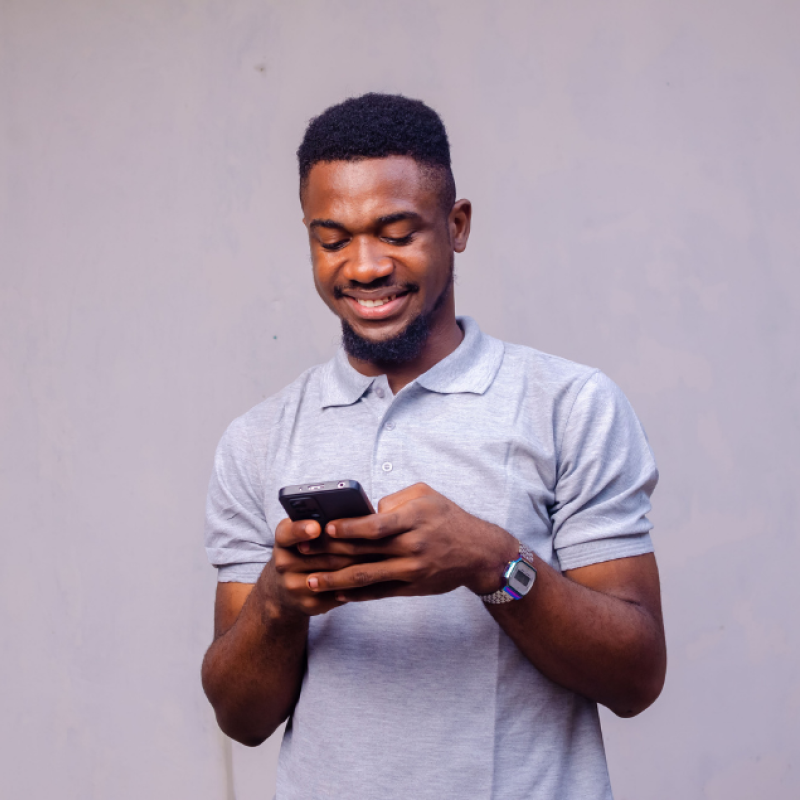 Smiling man looking at his mobile phone. 