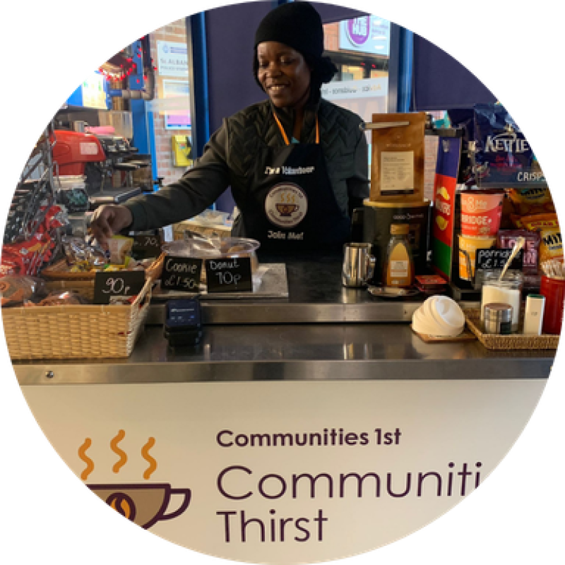 Volunteer Barista Smiling from behind the Communities Thirst Coffee Cart