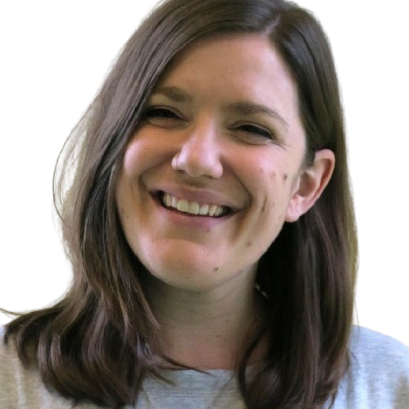 Photo of a woman with shoulder length dark straight hair. She is wearing white top and smiling at the camera