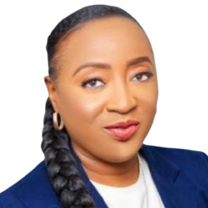 Photo of a woman. She is wearing her dark hair in a long braid which is draped over her shoulder. She is wearing a blue suit jacket with a white top