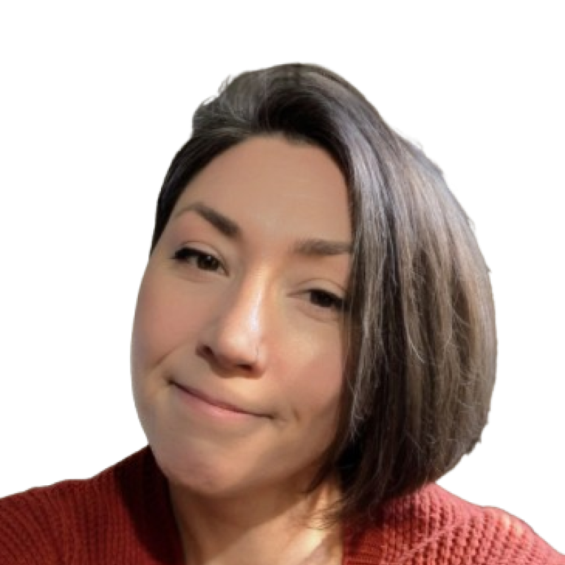 Photograph of a woman with short dark hair. She is wearing a red top