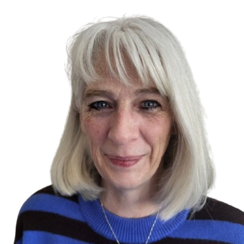 Photo of a woman with shoulder length white blonde hair. She is wearing a black and blue striped top