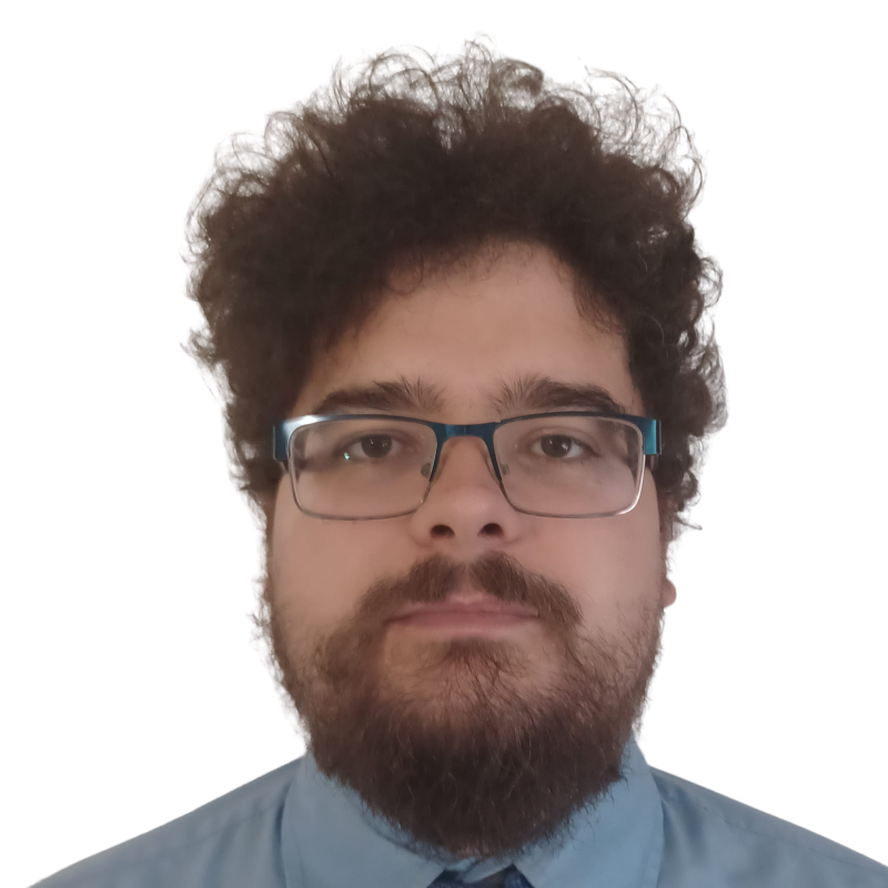 photograph of a man with curly hair and glasses