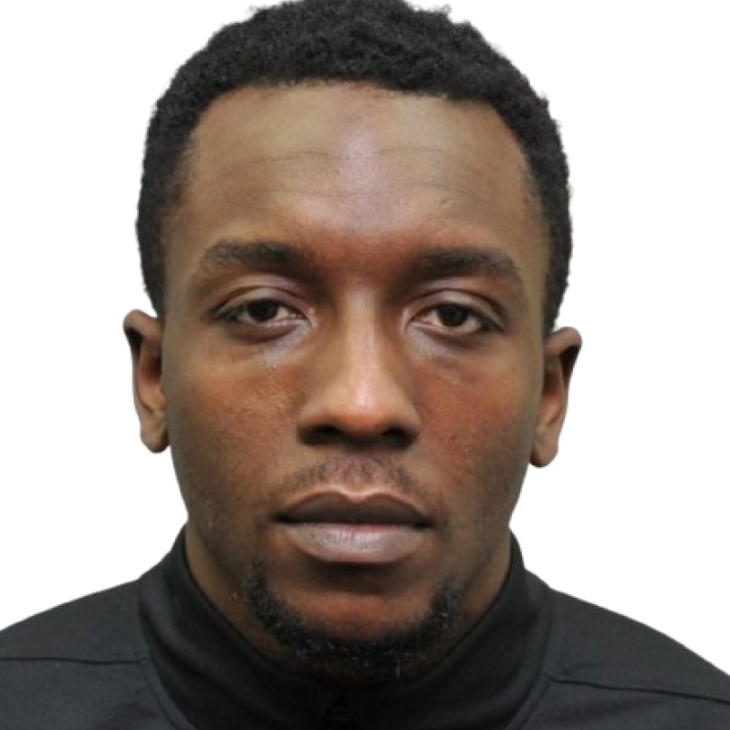 headshot of a man with short hair and wearing a black jumper